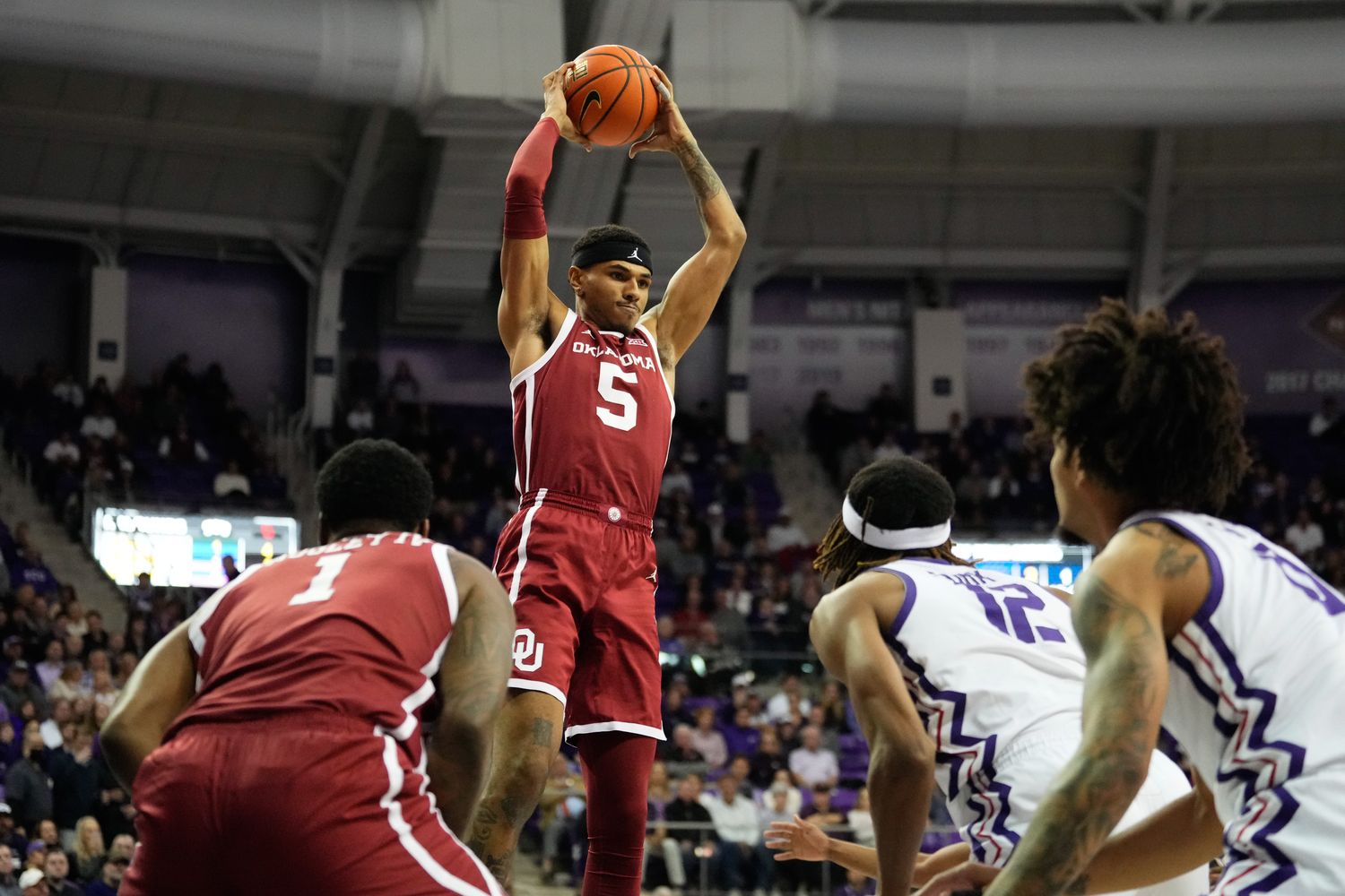 Jan 10, 2024; Fort Worth, Texas, USA; Oklahoma Sooners guard Rivaldo Soares (5) grabs a rebound against TCU Horned Frogs forward Xavier Cork (12) during the first half at Ed and Rae Schollmaier Arena. Mandatory Credit: Chris Jones-USA TODAY Sports  